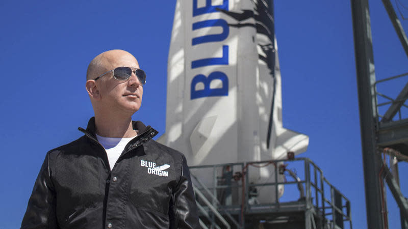 Blue Origin's New Shepard rocket, seen here with company owner Jeff Bezos, will boost passengers on sub-orbital trips above the internationally recognized 62-mile-high 