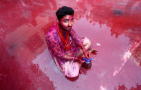 <p>A Hindu devotee takes part in the religious festival of Holi inside a temple in Nandgaon village, in the state of Uttar Pradesh, India, Feb. 25, 2018. (Photo: Adnan Abidi/Reuters) </p>