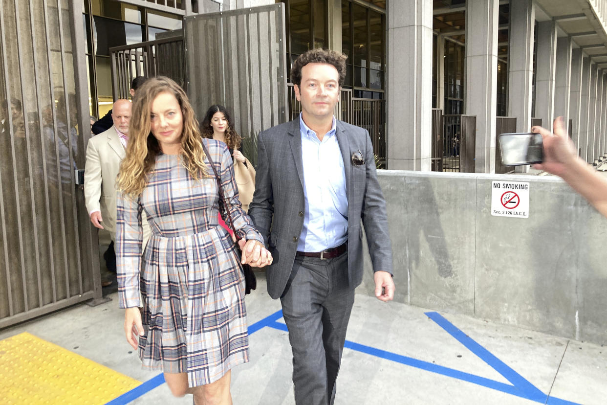 Danny Masterson, in a suit, and his wife, Bijou Phillips, in a plaid dress, outside Los Angeles Superior Court in 2022.