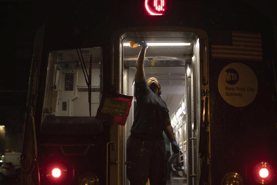 FILE - In this March 3, 2020, file photo, Metropolitan Transportation Authority worker sanitizes surfaces at the Coney Island Yard, in the Brooklyn borough of New York. As cases of the coronavirus surge in Italy, Iran, South Korea, the U.S. and elsewhere, many scientists say it's plain that the world is in the grips of a pandemic — a serious global outbreak. (AP Photo/Kevin Hagen, File)