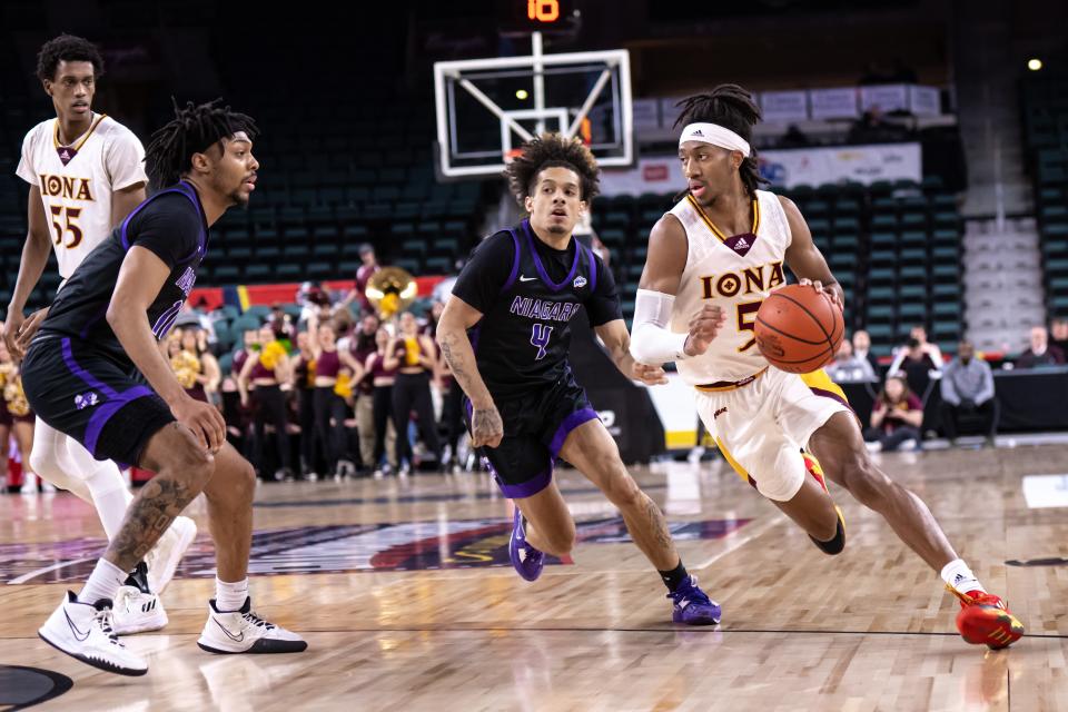 Mar 10, 2023; Atlantic City, NJ, USA; Iona Gaels guard Daniss Jenkins (5) drives to the basket against Niagara Purple Eagles guard Braxton Bayless (4) during the first half at Jim Whelan Boardwalk Hall. Mandatory Credit: John Jones-USA TODAY Sports