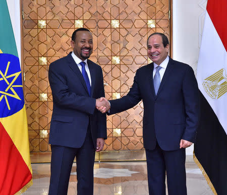 Egyptian President Abdel Fattah al-Sisi (R) shakes hands with Ethiopian Prime Minister Abiy Ahmed at the Ittihadiya presidential palace in Cairo, Egypt, June 10, 2018. in this handout picture courtesy of the Egyptian Presidency. The Egyptian Presidency/Handout via REUTERS