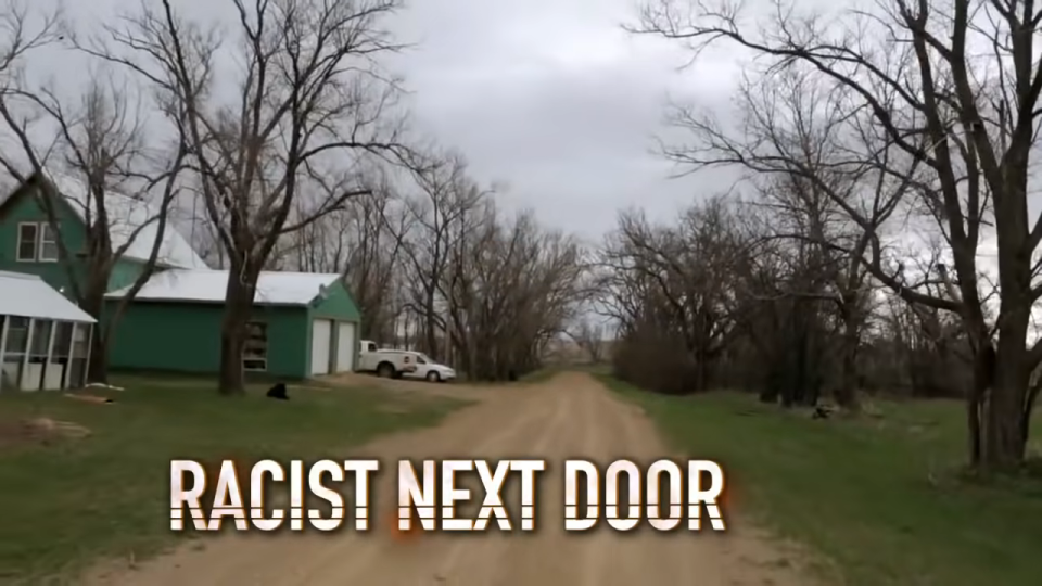 Dirt road leading to a green house with bare trees on the sides, captioned "RACIST NEXT DOOR"