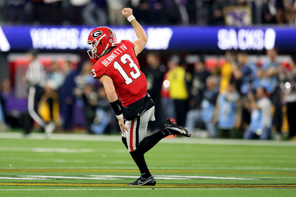 Stetson Bennett #13 of the Georgia Bulldogs reacts after a touchdown pass in the first quarter against the TCU Horned Frogs in the College Football Playoff National Championship game at SoFi Stadium on January 09, 2023 in Inglewood, California. / Credit: Ezra Shaw / Getty Images