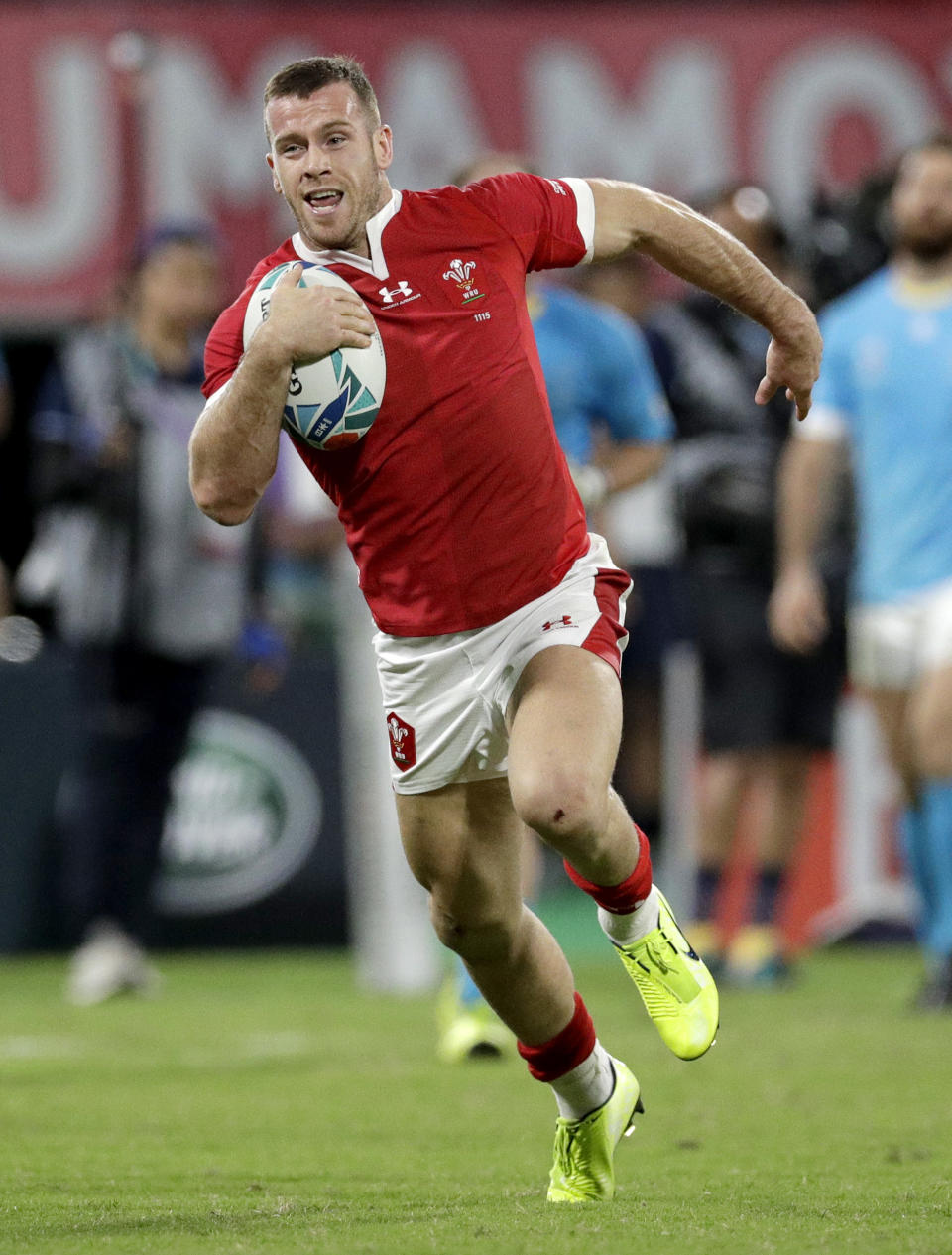 Wales' Gareth Davies runs in to score his team's final try during the Rugby World Cup Pool D game at Kumamoto Stadium between Wales and Uruguay in Kumamoto, Japan, Sunday, Oct. 13, 2019. Wales defeated Uruguay 35-13. (AP Photo/Aaron Favila)