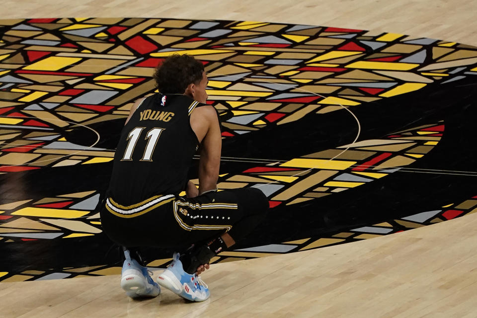 Atlanta Hawks guard Trae Young (11) watches as the Philadelphia 76ers shoot free throws in the final moments during the second half of Game 6 of an NBA basketball Eastern Conference semifinal series Friday, June 18, 2021, in Atlanta. (AP Photo/John Bazemore)