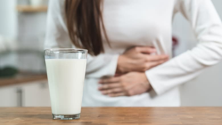 Milk and woman holding stomach