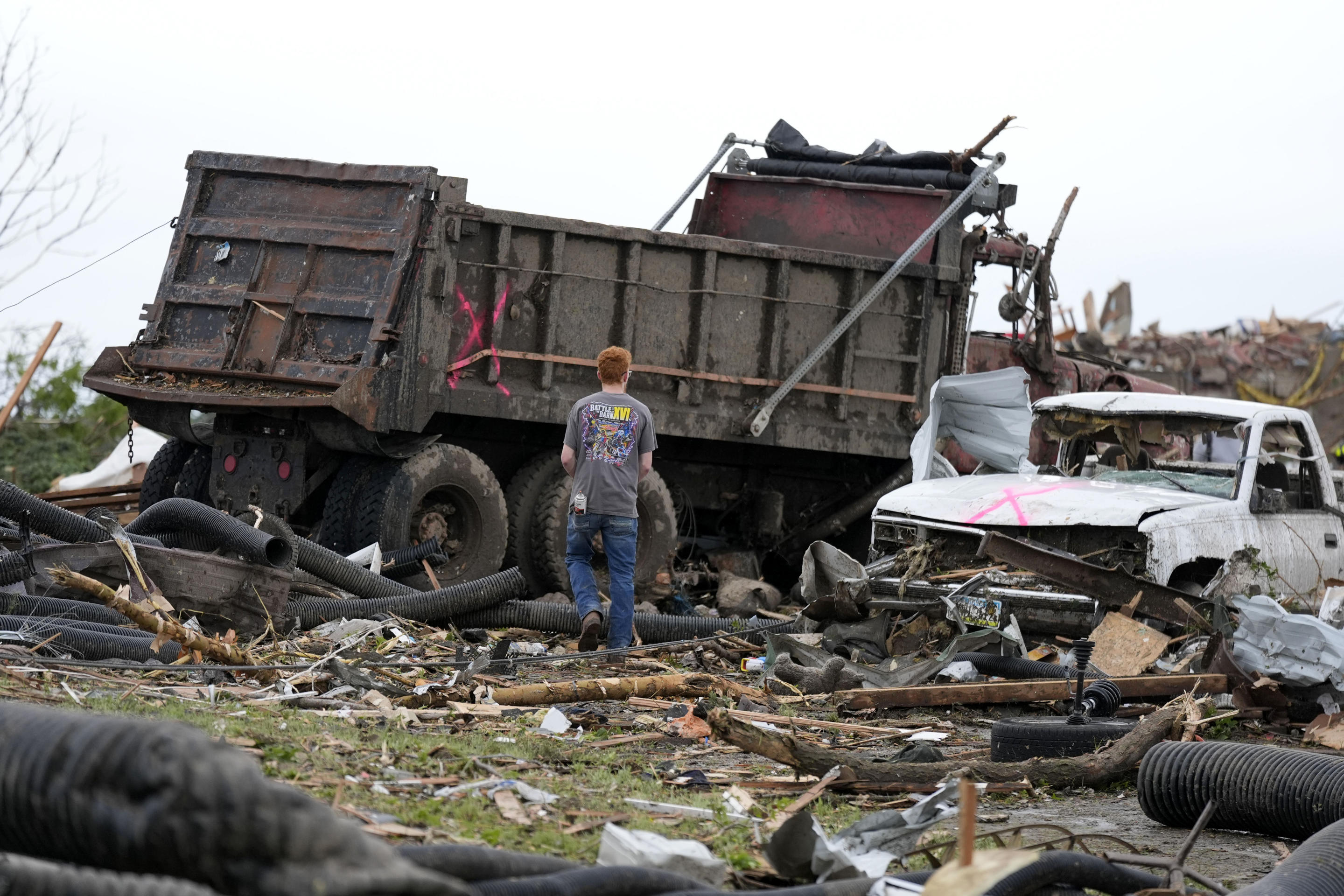 A workers searches through the remains of tornado-damaged property on Tuesday in Greenfield, Iowa.