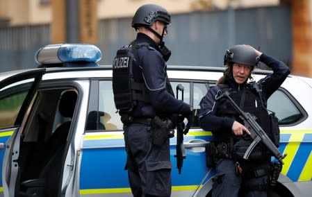 Police officers guard at the site of a shooting in Halle