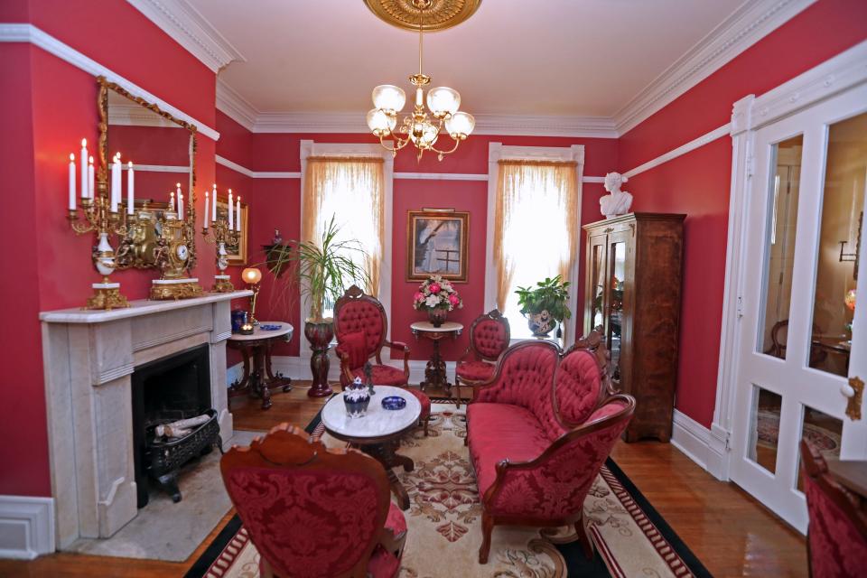 The parlor of the 1884 Italianate style home is dressed appropriately for the Victorian period in which it was built.