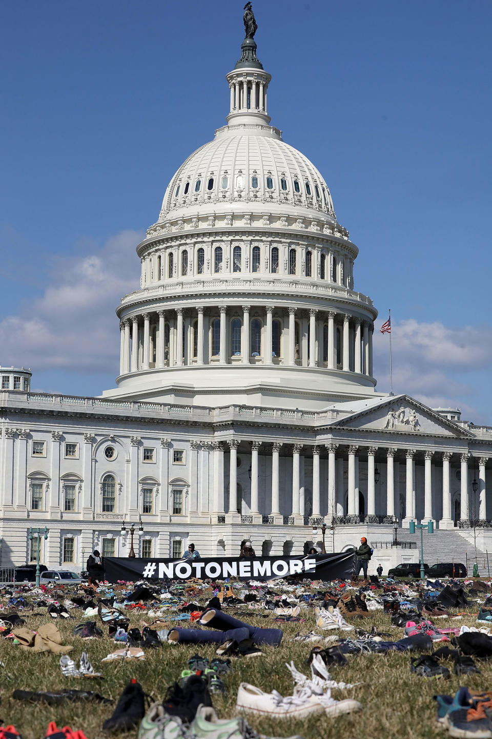 <p>7,000 pairs of shoes, representing the children killed by gun violence since the mass shooting at Sandy Hook Elementary School in 2012, are spread out on the lawn on the east side of the U.S. Capitol March 13, 2018 in Washington. (Photo: Chip Somodevilla/Getty Images) </p>