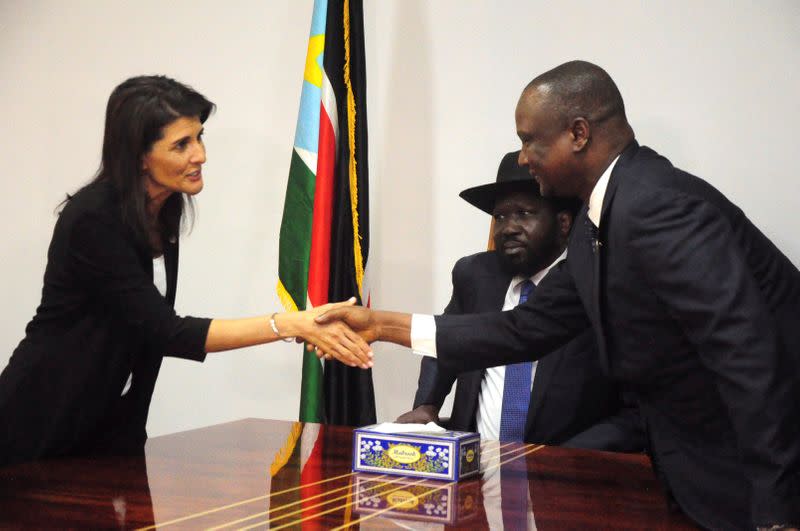 FILE PHOTO: U.S. Ambassador to the United Nations Nikki Haley greets South Sudan's First Vice President Taban Deng Gai next to South Sudan President Salva Kiir, in Juba