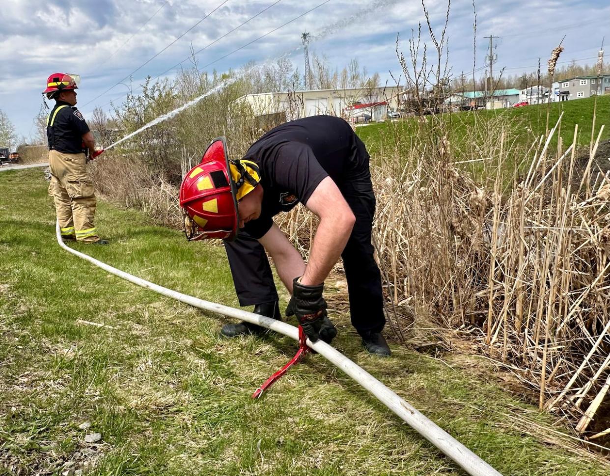 The weekend involved hosing techniques intended to make fire crews more efficient when fighting wildfires in the so-called 'urban interface.' (Natalia Goodwin/CBC  - image credit)