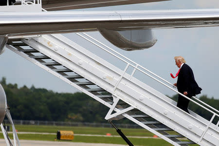 Republican presidential nominee Donald Trump boards his plane following a campaign rally in Tampa, Florida, U.S., August 24, 2016. REUTERS/Carlo Allegri