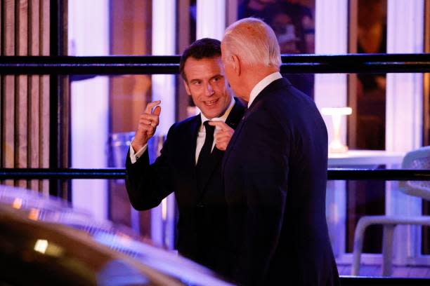 French president Emmanuel Macron (L) chats with US president Joe Biden as they leave Fiola Mare restaurant after a private dinner in Washington, DC, on 30 November 2022 (AFP via Getty Images)