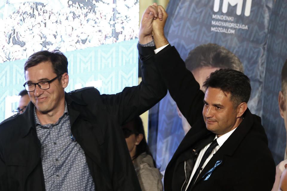 Conservative independent candidate Peter Marki-Zay, right, celebrates with Budapest's Mayor Gergely Karacsony in Budapest, Hungary, Sunday, Oct. 17, 2021, after he won an opposition primary race in Hungary, making him nominee of a six-party opposition coalition who will lead a challenge to right-wing populist Prime Minister Viktor Orban in national elections next spring . (AP Photo/Laszlo Balogh)