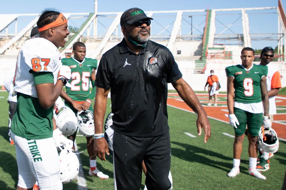 Florida A&M University Associate Head Coach James Spady reacts after having a jug of ice water dumped on him after his team was victorious in FAMU's final intersquad practice at Bragg Memorial Stadium Saturday, April 3, 2021.