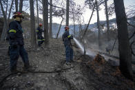 Firemen work at the University of Cape Town Campus in Cape Town, Monday April 19, 2021. People were evacuated from Cape Town neighborhoods as a raging wildfire sweeping across the slopes of the city’s famed Table Mountain was fanned by high winds and threatened homes. City authorities said the fire, which started early Sunday, was still not under control. The blaze has already burned the library and other buildings on the campus of the University of Cape Town. (AP Photo/Jerome Delay)