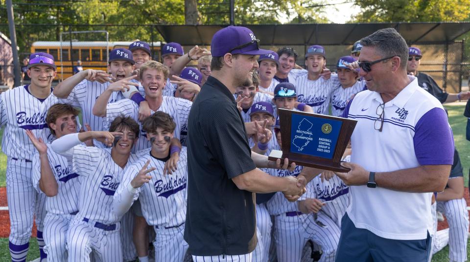 Rumson-Fair Haven coach Owen Stewart (left) receives the NJSIAA Central Group 2 championship plaque from Rumson-Fair Haven athletic director Chris Lanzalotto