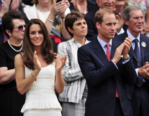 Britain's Prince William (R) and his wife Catherine the Duchess of Cambridge (L) applaud after watching Britain's Andy Murray beat France's Richard Gasquet at the 2011 Wimbledon Tennis Championships at the All England Tennis Club in London