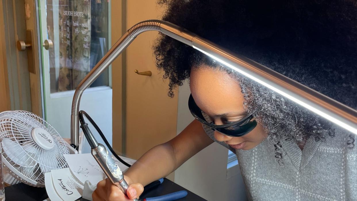 a catbird welder puts on the permanent jewelry