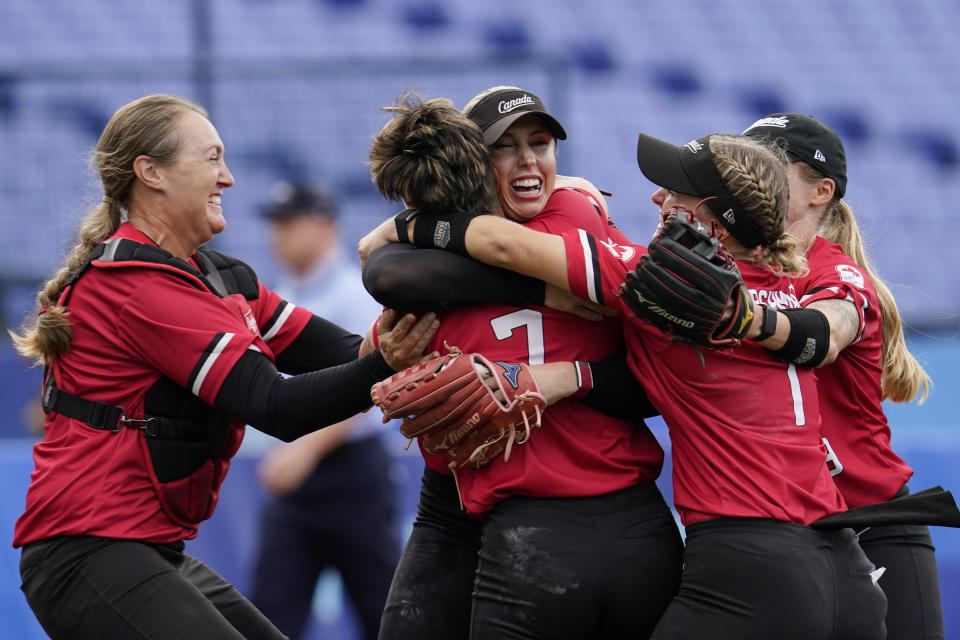 Canada's Danielle Lawrie, center right, celebrate with teammates after a softball game against Mexico at the 2020 Summer Olympics, Tuesday, July 27, 2021, in Yokohama, Japan. Canada won 3-2. (AP Photo/Sue Ogrocki)