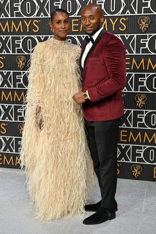 <p>ROBYN BECK/AFP via Getty</p> Issa Rae and Louis Diame