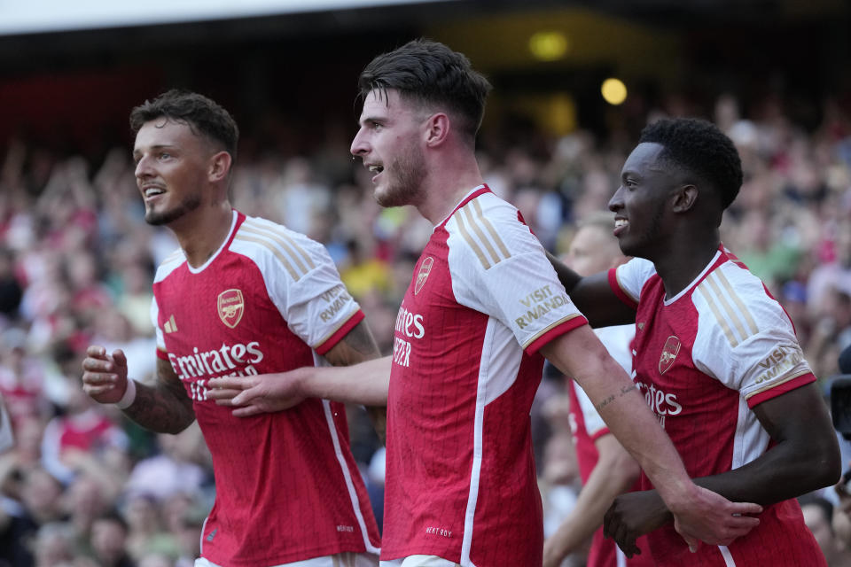 Arsenal's Declan Rice, center, celebrates with teammates after scoring his side's second goal during the English Premier League soccer match between Arsenal and Manchester United at Emirates stadium in London, Sunday, Sept. 3, 2023. (AP Photo/Kirsty Wigglesworth)