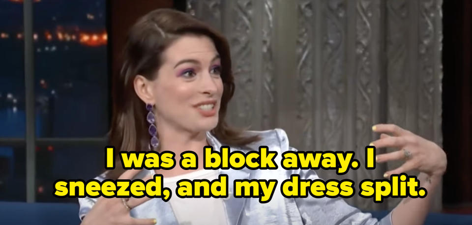 Anne Hathaway saying, "I was a block away. I sneezed, and my dress split."