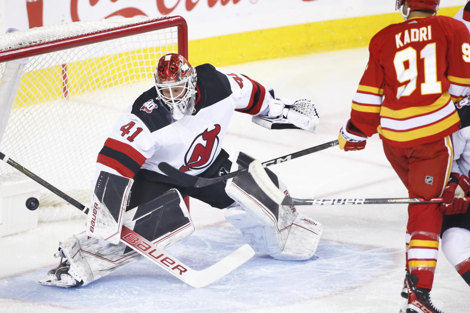 New Jersey Devils goalie Vitek Vanecek gives up a goal to Calgary Flames' Nazem Kadri during the first period of an NHL hockey game Saturday, Nov. 5, 2022, in Calgary, Alberta. (Larry MacDougal/The Canadian Press via AP)