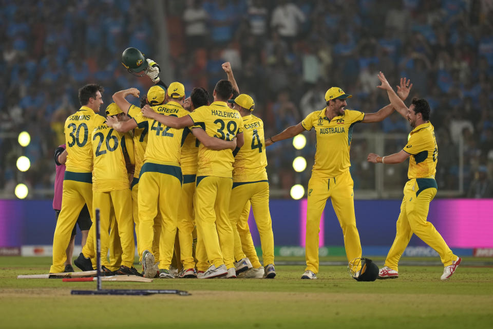 Australia's Travis Head, right, and teammates celebrate after their win in the ICC Men's Cricket World Cup final match against India in Ahmedabad, India, Sunday, Nov. 19, 2023. (AP Photo/Aijaz Rahi)