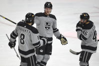 Los Angeles Kings defenseman Olli Maatta, center, celebrates an assist by defenseman Drew Doughty, left, on a goal by center Blake Lizotte, right, during the second period of an NHL hockey game against the Minnesota Wild in Los Angeles, Saturday, Jan. 16, 2021. (AP Photo/Kelvin Kuo)