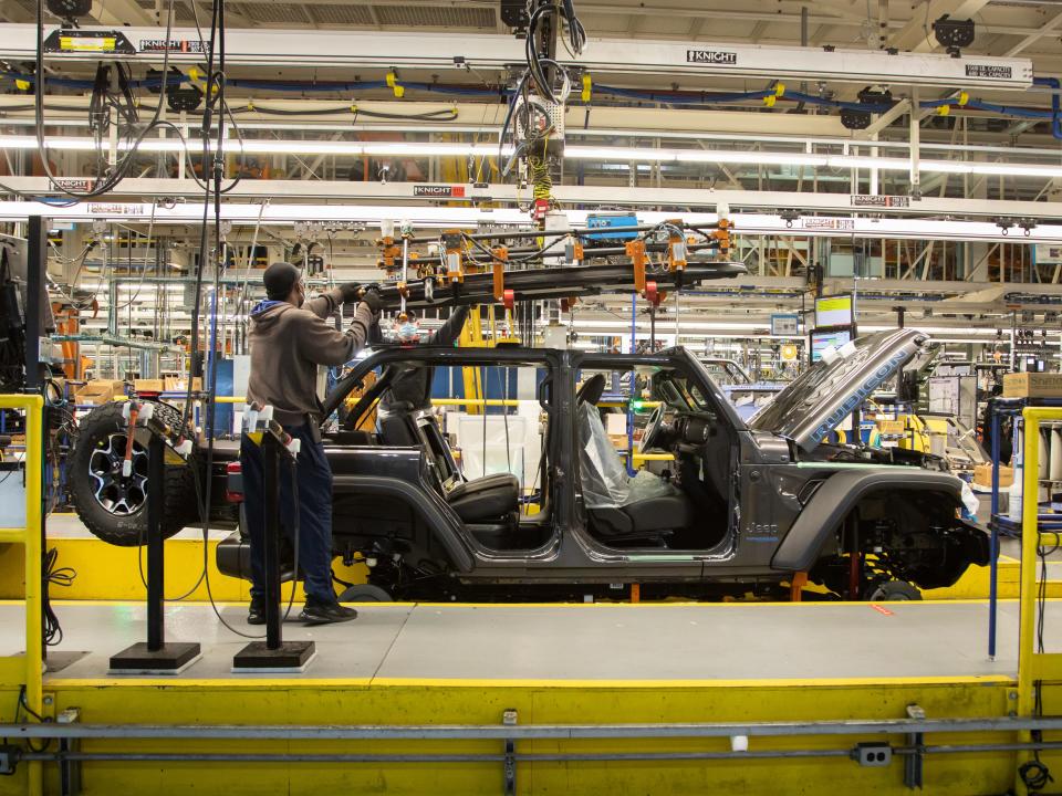 An employee at FCA’s Toledo North Assembly Plant works on the 2021 Jeep Wrangler 4xe.