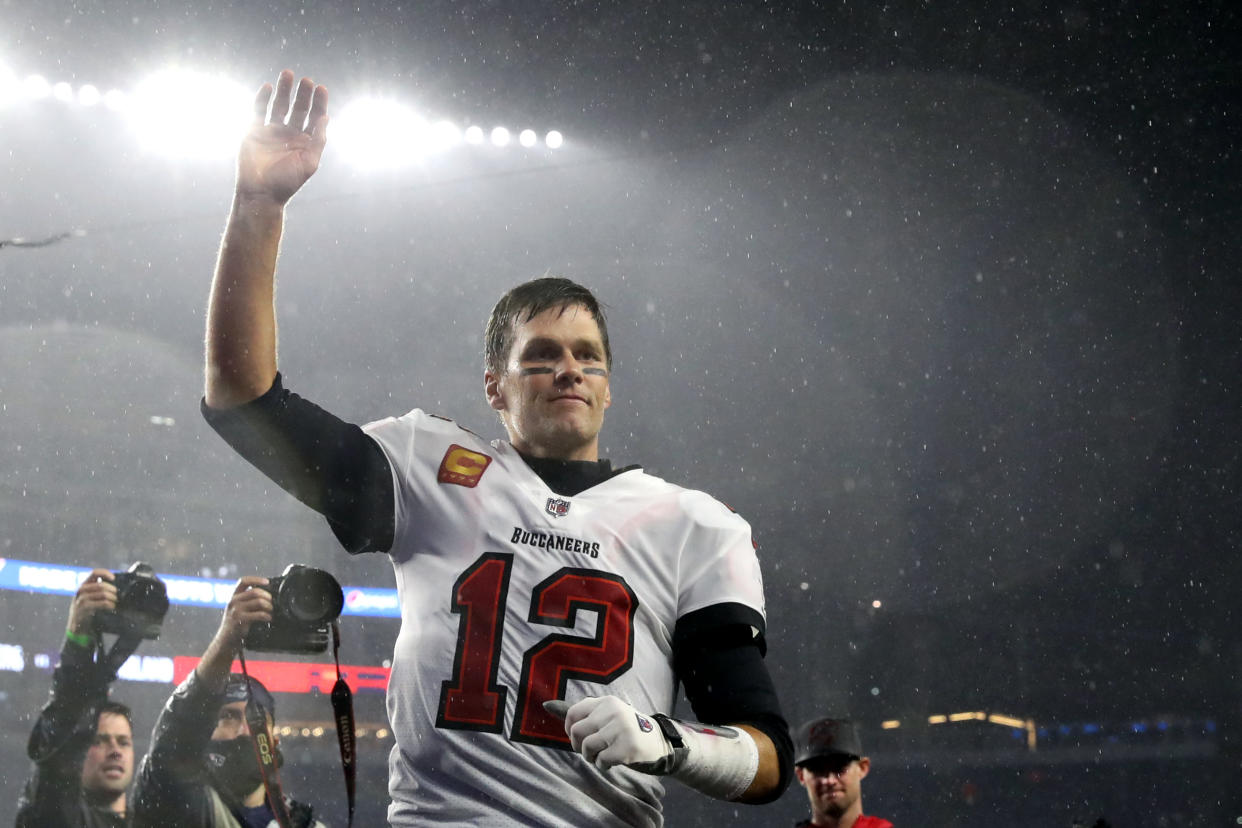 FOXBOROUGH, MASSACHUSETTS - OCTOBER 03: Tom Brady #12 of the Tampa Bay Buccaneers waves to the crowd as he runs off the field after defeating the New England Patriots in the game at Gillette Stadium on October 03, 2021 in Foxborough, Massachusetts. (Photo by Maddie Meyer/Getty Images)