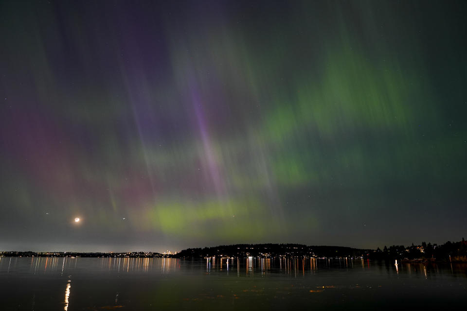 The northern lights, or aurora borealis, are visible over Lake Washington, in Renton, Wash., on Friday evening, May 10, 2024. (AP Photo/Lindsey Wasson)