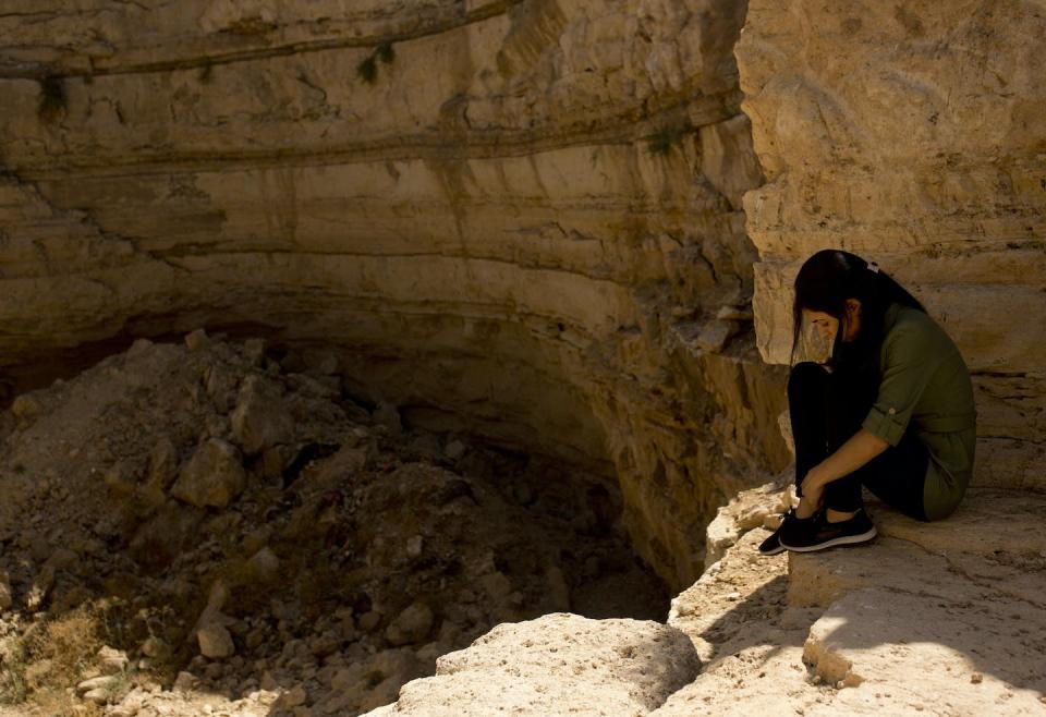 A Yazidi woman who was held captive by the Islamic State visits the mass grave where her husband is believed to be buried in Iraq. <a href="https://newsroom.ap.org/detail/YazidiSlaveTrade/994255e1eb3a4296afa1a3f3599d7192/photo?Query=yazidi&mediaType=photo&sortBy=arrivaldatetime:desc&dateRange=Anytime&totalCount=755&currentItemNo=6" rel="nofollow noopener" target="_blank" data-ylk="slk:AP Photo/Maya Alleruzzo;elm:context_link;itc:0;sec:content-canvas" class="link ">AP Photo/Maya Alleruzzo</a>