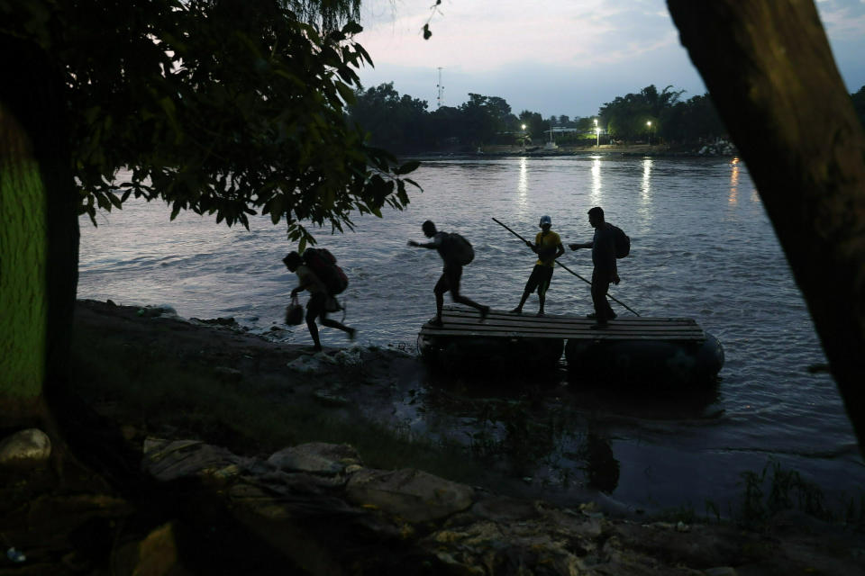Migrants on rafts reach the Mexico shore after crossing the Suchiate River from Guatemala, near Ciudad Hidalgo, Mexico, Wednesday, June 5, 2019. Hundreds more Central American migrants have crossed into Mexico from Guatemala, and a group of about 1,000 have started walking en mass to the north. (AP Photo/Marco Ugarte)