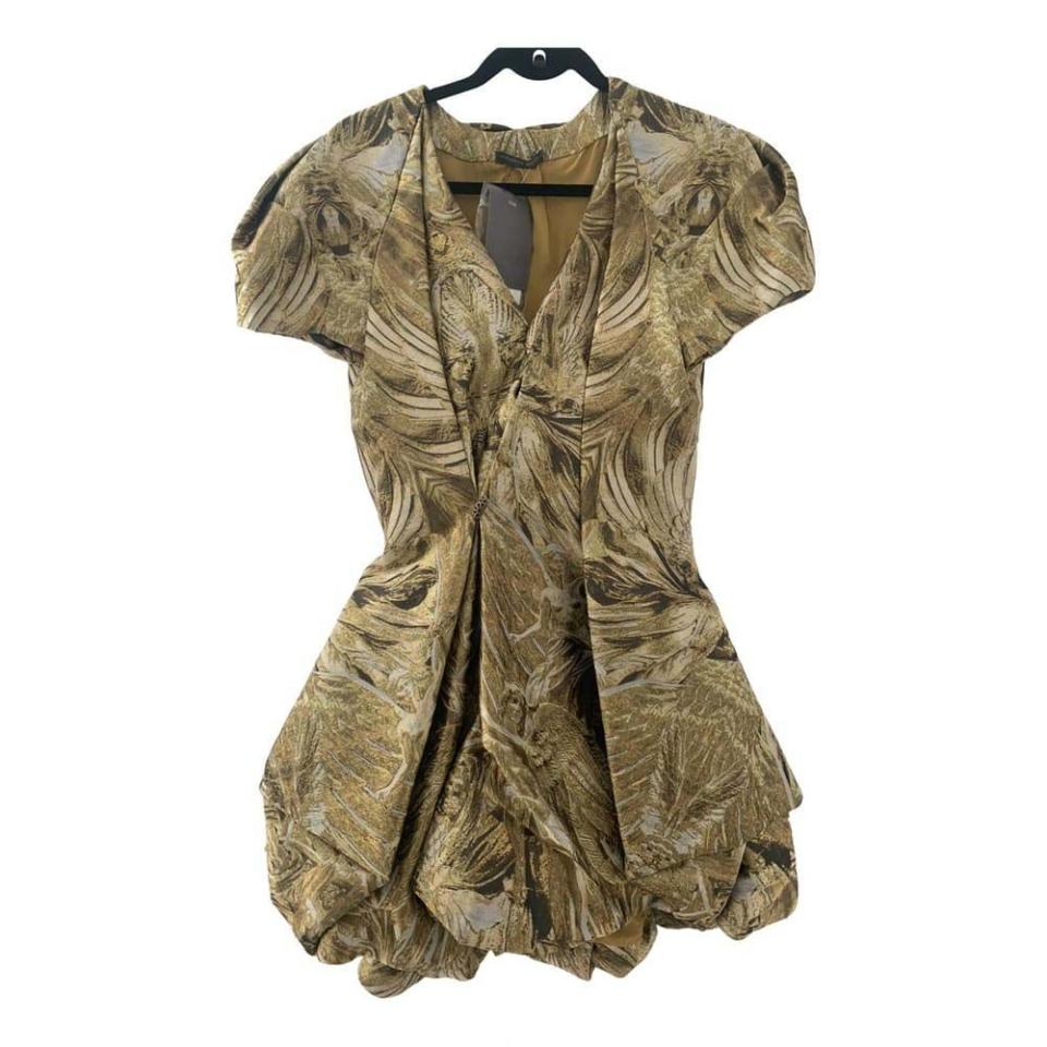 <p><a class="link " href="https://www.vestiairecollective.com/women-clothing/dresses/alexander-mcqueen/gold-silk-alexander-mcqueen-dress-24547760.shtml" rel="nofollow noopener" target="_blank" data-ylk="slk:SHOP NOW;elm:context_link;itc:0;sec:content-canvas">SHOP NOW</a></p><p>This rare couture piece is part of Alexander McQueen’s final collection, which, though unfinished at the time of his death, was shown a month later as part of a memorial show. The collection was inspired by Byzantine art, of which this dress, decorated with digitally printed images of angels and wings, is a poignant reminder.<br></p>