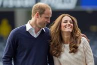 Catherine (R), Duchess of Cambridge, and her husband, Britain's Prince William, laugh as they watch a young players' rugby tournament held at Forsyth Barr Stadium in Dunedin April 13, 2014. Prince William and his wife are undertaking a 19-day official visit to New Zealand and Australia with their son, Prince George. REUTERS/David Rowland/Pool (NEW ZEALAND - Tags: SOCIETY ROYALS SPORT RUGBY TPX IMAGES OF THE DAY)