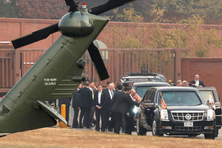 White House senior staff discuss the situation as U.S. President Donald Trump sits in his car after being grounded from an attempt to visit the Demilitarized Zone (DMZ) in the truce village of Panmunjom dividing North Korea and South Korea, at a U.S. military post in Seoul, South Korea, November 8, 2017. REUTERS/Jonathan Ernst