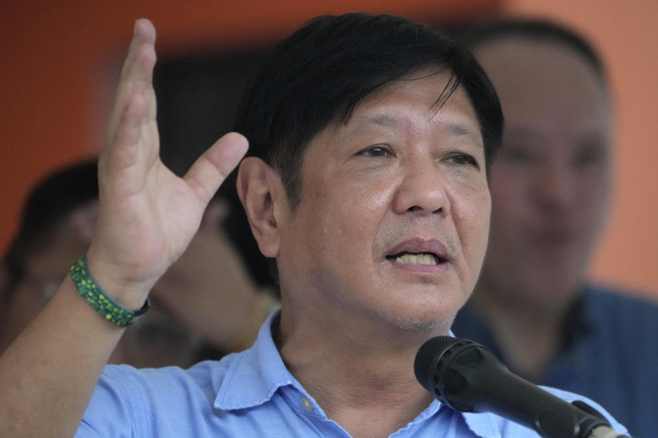 Philippine President Ferdinand Marcos Jr. gestures during his speech as he visits an evacuation center in Guinobatan town, Albay province, northeastern Philippines, Wednesday, June 14, 2023. A gentle eruption of the Philippines' most active volcano that has forced nearly 18,000 people to flee to emergency shelters could last for months and create a protracted crisis, officials said Wednesday. (AP Photo/Aaron Favila)