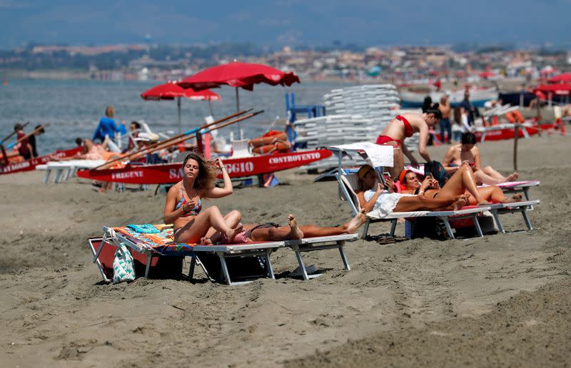 Italians sunbathe at the beach after it officially reopened for the first time following the country's strict coronavirus disease (COVID-19) lockdown, in Fregene