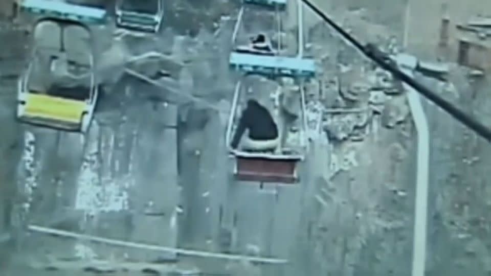 The man stands up before jumping off the chairlift. Photo: Security footage