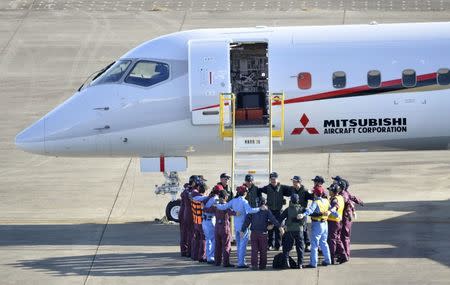 Flight crew members form a circle before taking off in Mitsubishi Aircraft Corp's Mitsubishi Regional Jet (MRJ) for a test flight at Nagoya Airfield in Toyoyama town, Aichi Prefecture, central Japan, in this photo taken by Kyodo November 11, 2015. Mandatory credit REUTERS/Kyodo