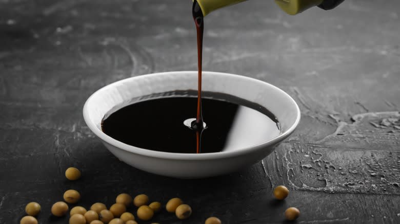 soy sauce being poured into bowl