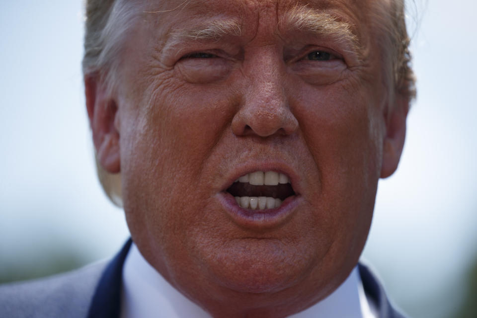 President Donald Trump talks with reporters on the South Lawn of the White House before departing to Japan for the G-20 summit, Wednesday, June 26, 2019, in Washington. (AP Photo/Evan Vucci)