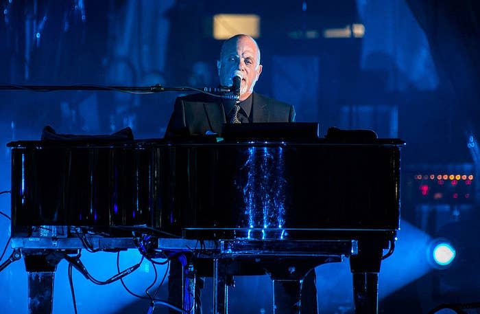 Joel singing and playing piano onstage