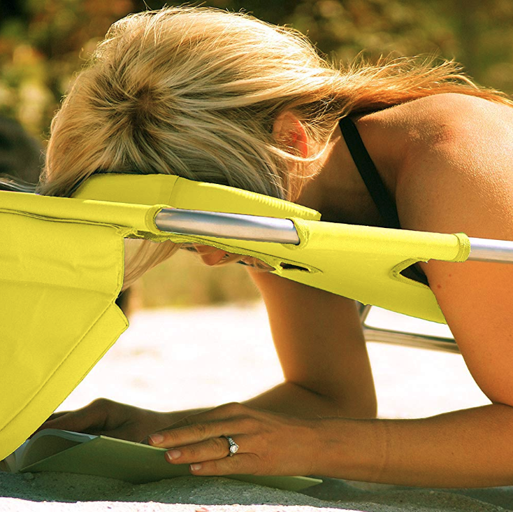 woman reading a book through her lounge chair