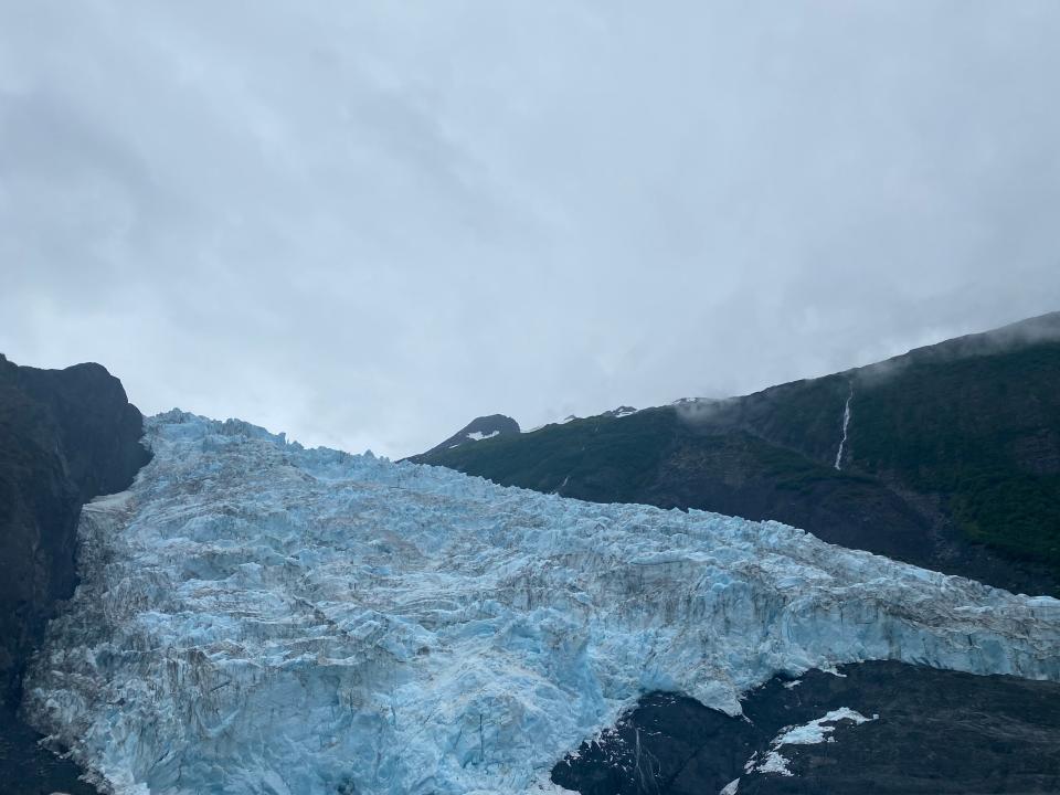 light blue glacier surrounded by rock