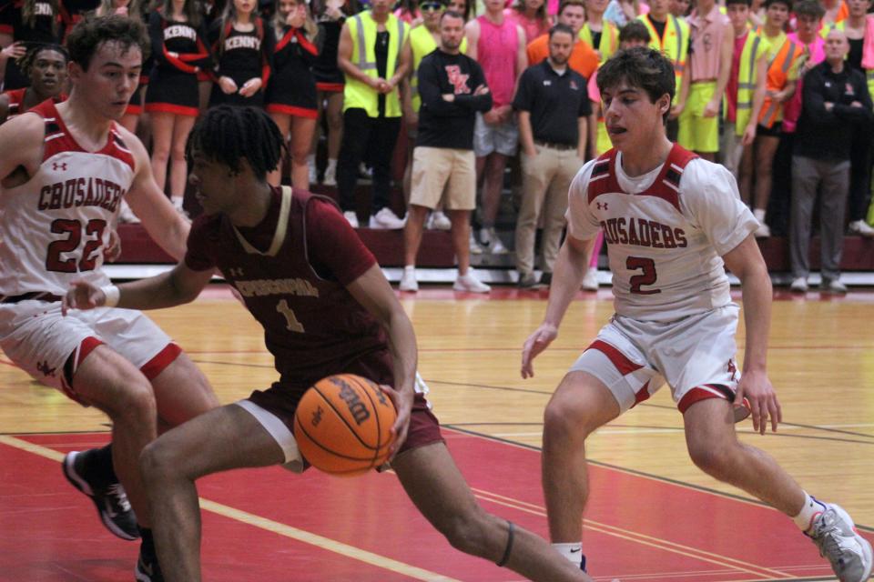 Episcopal guard Beza Miller (1) dribbles as Bishop Kenny's Max Davis (22) and Barrett Baker (2) defend during a high school boys basketball game on January 20, 2023. [Clayton Freeman/Florida Times-Union]